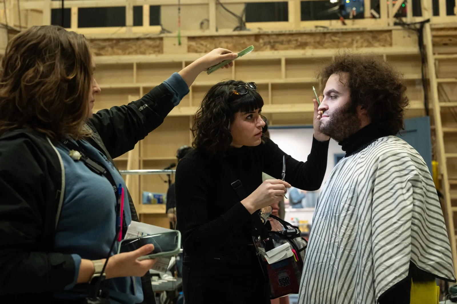 Hair Makeup team doing touchups on Matt Wood on the set of Columbia Pictures' SATURDAY NIGHT.